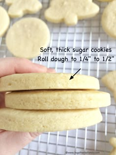 a person is holding up some cookies on a cooling rack with the words soft, thick sugar cookies roll dough to 1 / 4 to 12 inches