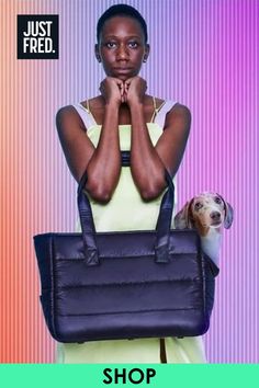 Image shows Just Fred's limited edition weekend dog tote. A stylish woman in a yellow dress is holding the bag with a large dachshund in it.  Shop at Just Fred now.