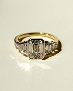 three stone diamond ring on white surface