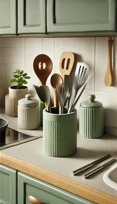 kitchen utensils and spoons in a green container