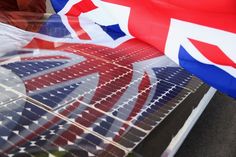 the union jack flag is reflected in an array of solar panels