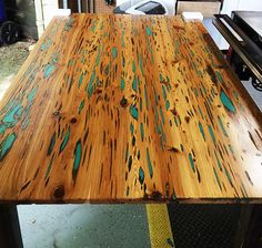 a wooden table with blue paint on it