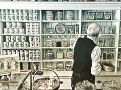 a man standing in front of a counter filled with food