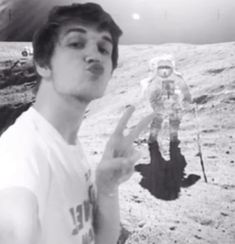 a man making the peace sign on the moon