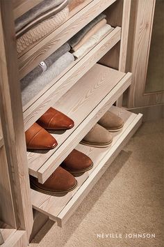 shoes are lined up on the bottom shelf in this walk - in closet with drawers