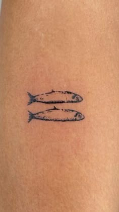 two fish on the back of a woman's thigh