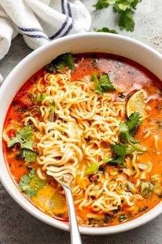 a bowl of soup with noodles and cilantro