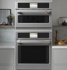 two ovens side by side in a kitchen with stainless steel cabinets and counter tops