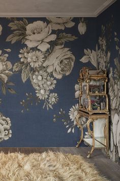 a room with a floral wallpaper and rug