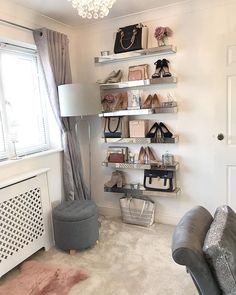 a living room filled with furniture and lots of shelves on the wall next to a window