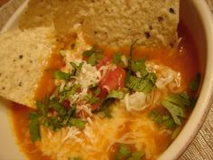 a white bowl filled with soup and tortilla chips