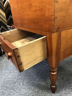 a wooden bed frame with drawers on the bottom