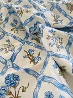 a blue and white fabric with flowers on it