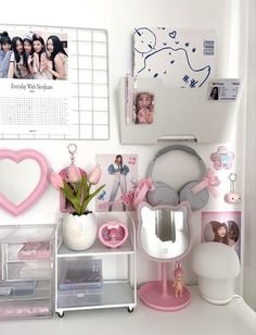 a white desk topped with lots of pink items