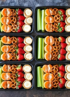 six trays filled with pretzels, strawberries and celery