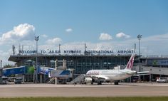 an airplane is parked in front of the airport