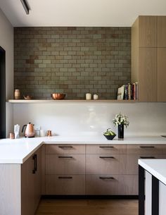 a kitchen with wooden cabinets and white counter tops