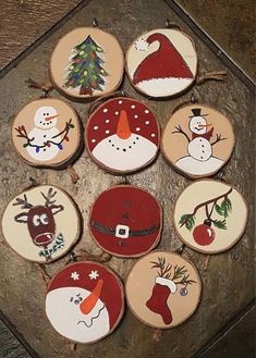 twelve decorated christmas cookies in the shape of santa claus and snowmen on wooden boards