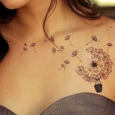 a woman with a tattoo on her chest has a dandelion in the shape of a vase