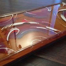 a close up of a glass table with an artistic design on the top and bottom