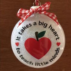 a glass ornament that says it takes a big heart to teach little minds