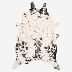 a black and white cowhide rug with spots on it's back end, against a white background