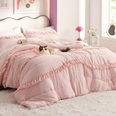 a cat laying on top of a pink comforter in a room with white carpet