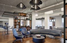 an office with couches, chairs and tables