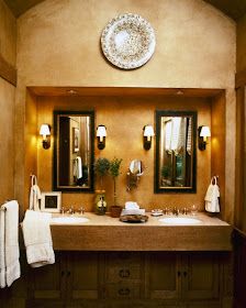 a bathroom with two sinks and mirrors on the wall