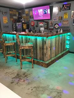 the bar is made out of pallet boards and has two chairs at one end