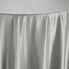 an image of a white table cloth draped over it's headboard and back