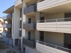 an apartment building with balconies and balcony railings