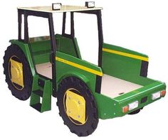 a green toy tractor sitting on top of a white floor next to a yellow stripe