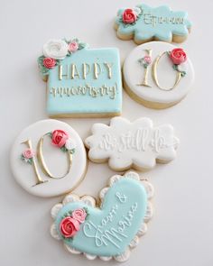 decorated cookies are arranged on a white surface