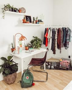 a room with a white desk and some plants