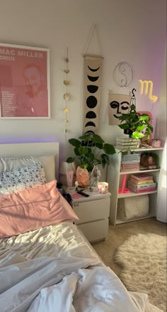 a bedroom with pink and white decor on the walls, bed linens and pillows