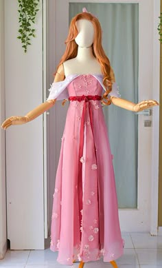 a mannequin wearing a pink dress with flowers on it