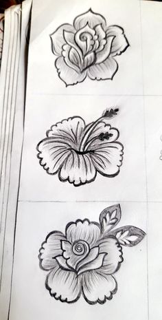 some flowers are drawn on paper and placed on top of each other with pencils