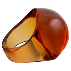 an orange and yellow glass ring on a white background with clippings to the side