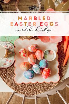 marbled easter eggs with colorful decorations on a white plate and wicker table cloth