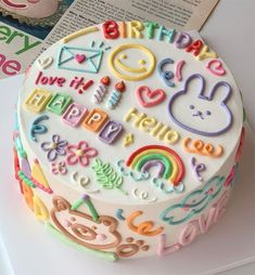 a birthday cake is decorated with colorful letters