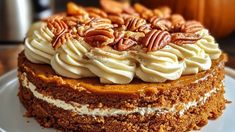 a close up of a cake on a plate with frosting and pecans in the background