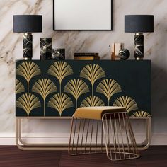 an art deco sideboard with black and gold designs on it, along with two lamps