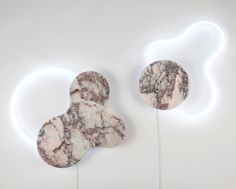 two white and black marbled objects on sticks