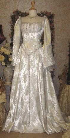 a white wedding dress on display in a room