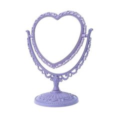 a white heart shaped stand on top of a table