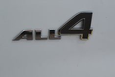 the four letter alfa logo is shown in black and silver on a white car's emblem