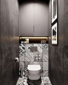 a bathroom with black and white tiles on the walls