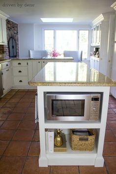 a kitchen with an island and microwave in it