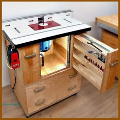 an open cabinet with tools in it on the floor